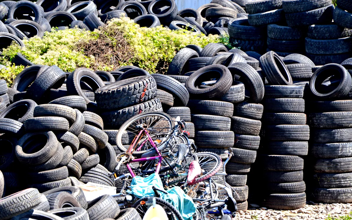 Stacks and heaps of used tyres waiting to be recycled.